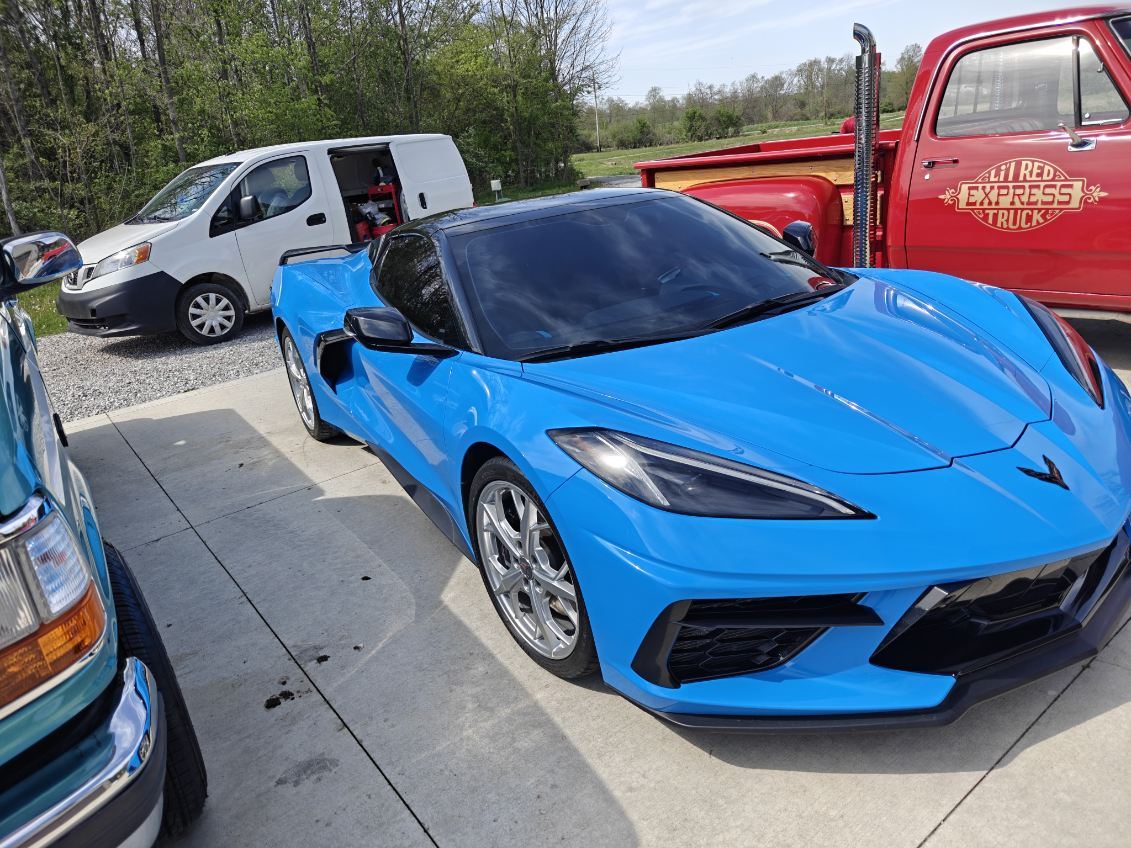 Freshly detailed blue Corvette Stingray outside the JMIDS shop